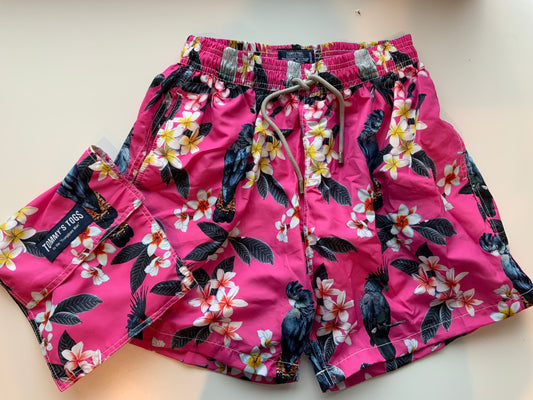 Black cockatoo, frangipani, pink shorts